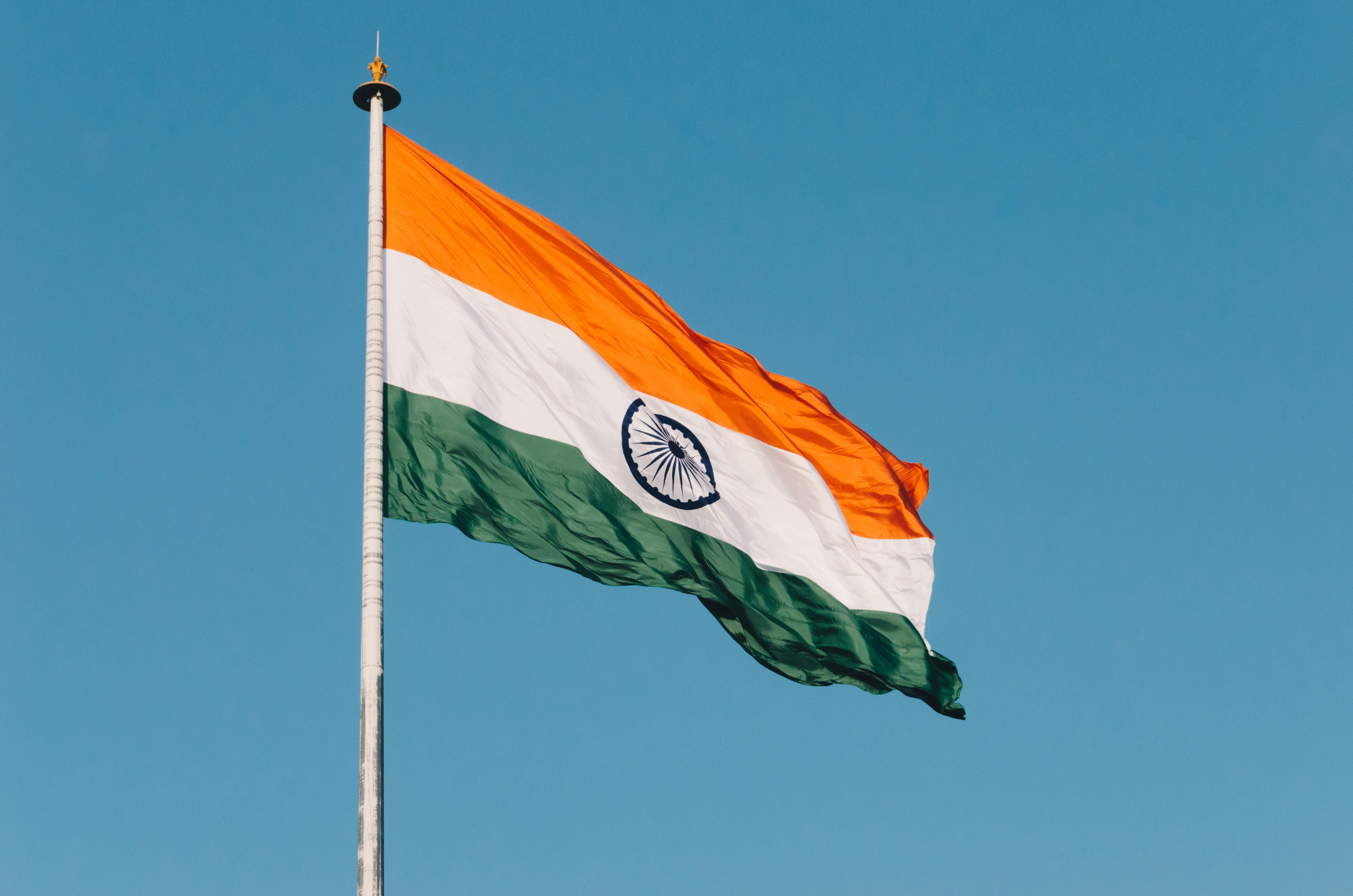 An indian flag on a blue sky